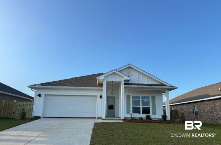 1081 Hayward Loop Foley, AL 36535 - Photo 1 of 46 Contemporary ranch-style exterior featuring a two-car garage, concrete driveway, and front lawn