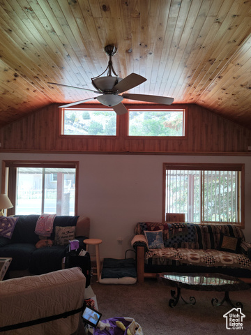 97 East Main Street Stockton, UT 84071 - Photo 38 of 58 Carpeted living room featuring wood ceiling, a ceiling fan, wooden walls, and high vaulted ceiling