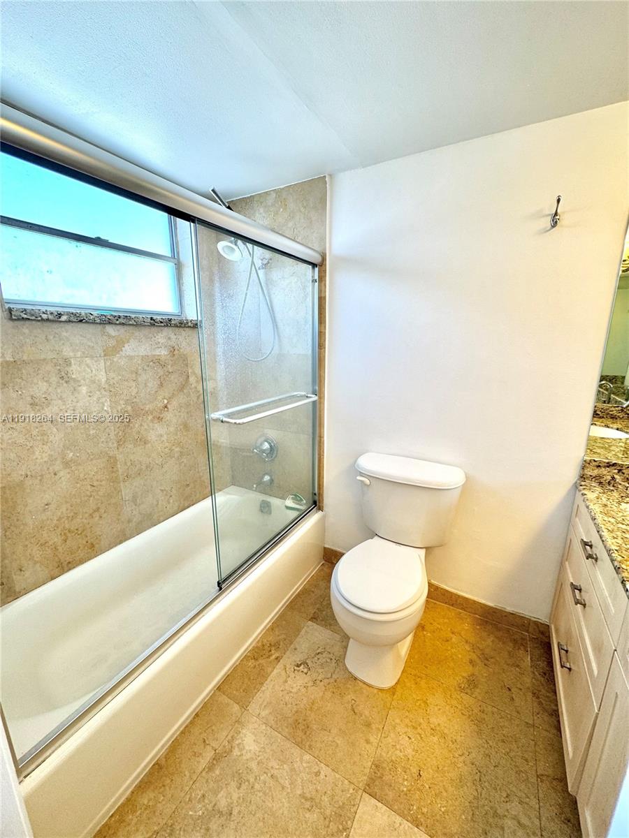 1020 94th Street, Unit 402 Bay Harbor Islands, FL 33154 - Photo 13 of 15 a bathroom with a toilet and a bathtub