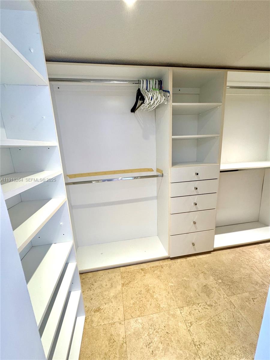 1020 94th Street, Unit 402 Bay Harbor Islands, FL 33154 - Photo 14 of 15 a view of walk in closet with empty racks