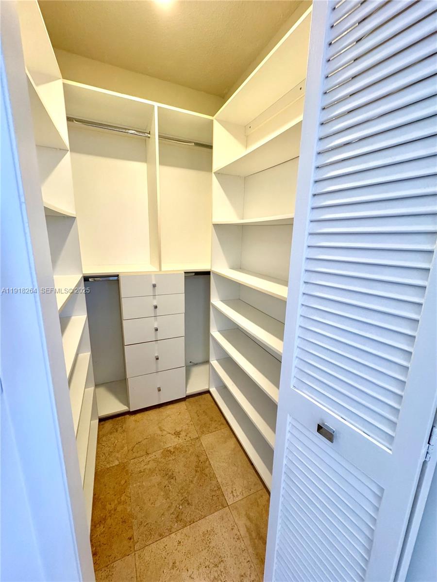 1020 94th Street, Unit 402 Bay Harbor Islands, FL 33154 - Photo 15 of 15 a view of walk in closet and wooden floor