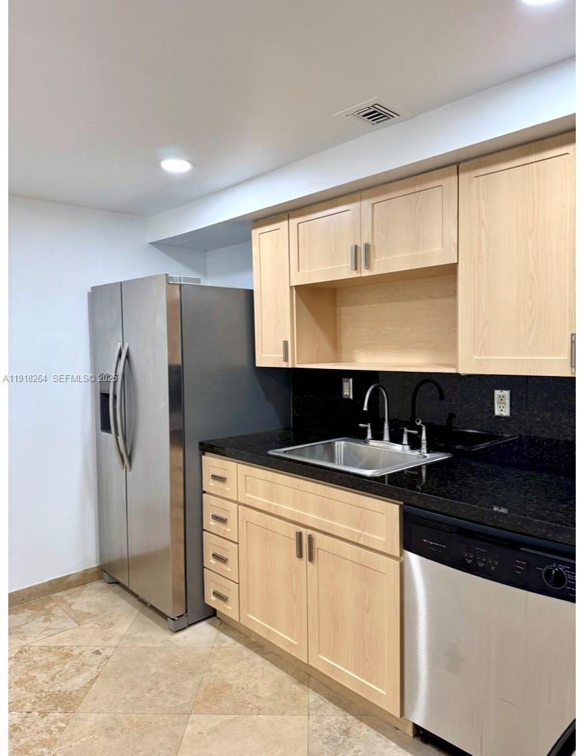 1020 94th Street, Unit 402 Bay Harbor Islands, FL 33154 - Photo 6 of 15 a kitchen with a sink and a refrigerator