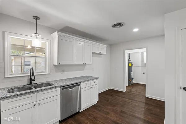 a kitchen with a sink cabinets and window