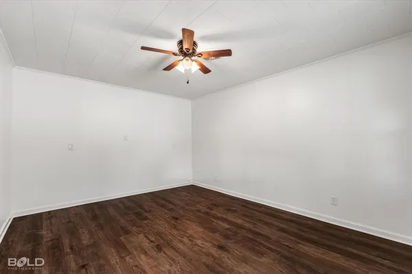 a view of a room with wooden floor and fan