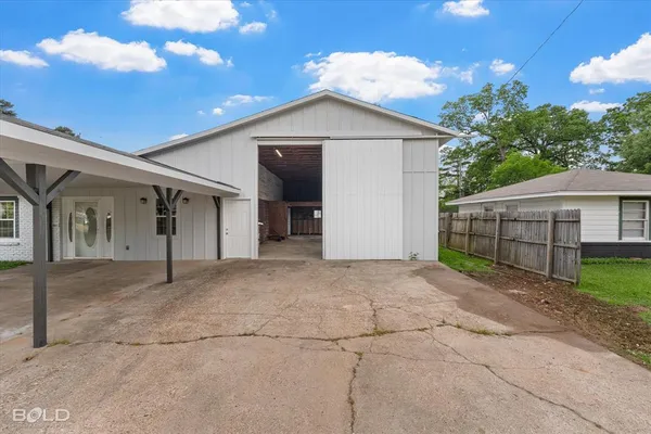 a view of a house with a yard and garage