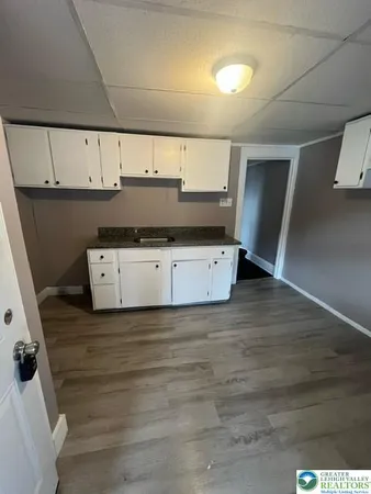 a view of kitchen with cabinets and wooden floor