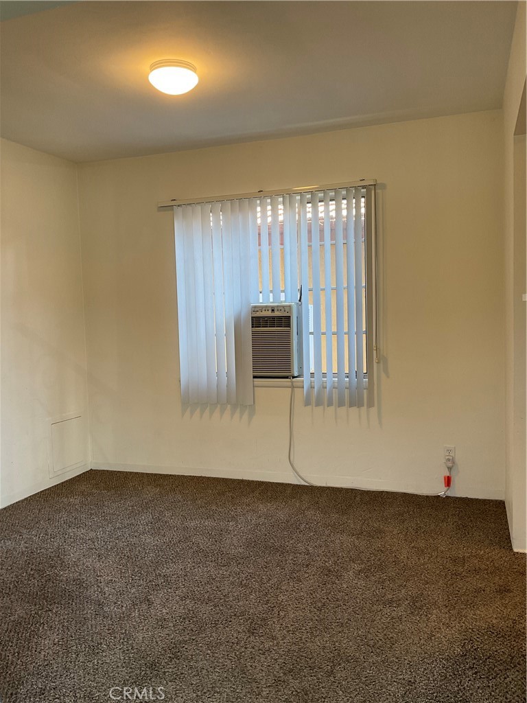 357 Grant Street, Unit A Redlands, CA 92373 - Photo 3 of 11 an empty room with wooden floor and windows
