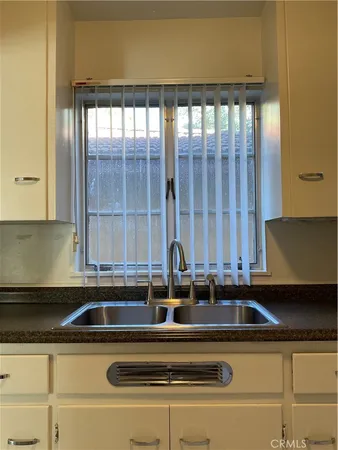 a stove top oven sitting inside of a kitchen