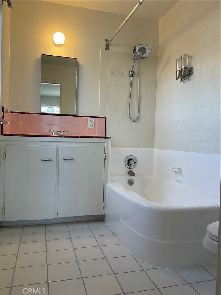 357 Grant Street, Unit A Redlands, CA 92373 - Photo 10 of 11 a bathroom with a granite countertop sink a toilet and mirror