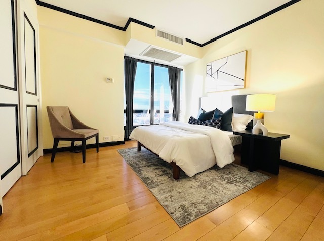 530 East 76th Street, Unit 35H36H Manhattan, NY 10021 - Photo 14 of 16 a bedroom with a bed a table and chair