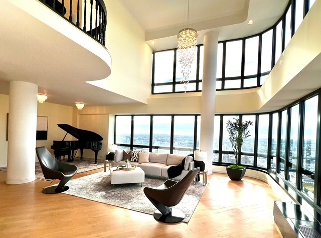 530 East 76th Street, Unit 35H36H Manhattan, NY 10021 - Photo 6 of 16 a living room with furniture and a large window