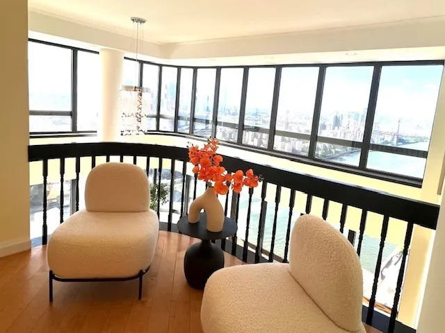 a balcony with table and chairs