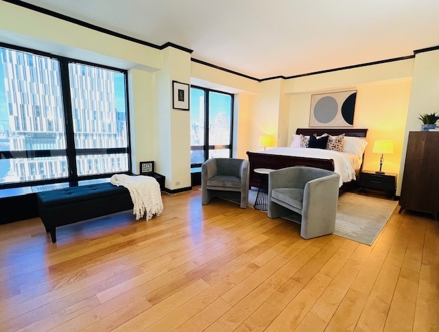 530 East 76th Street, Unit 35H36H Manhattan, NY 10021 - Photo 9 of 16 a bedroom with furniture and a large window