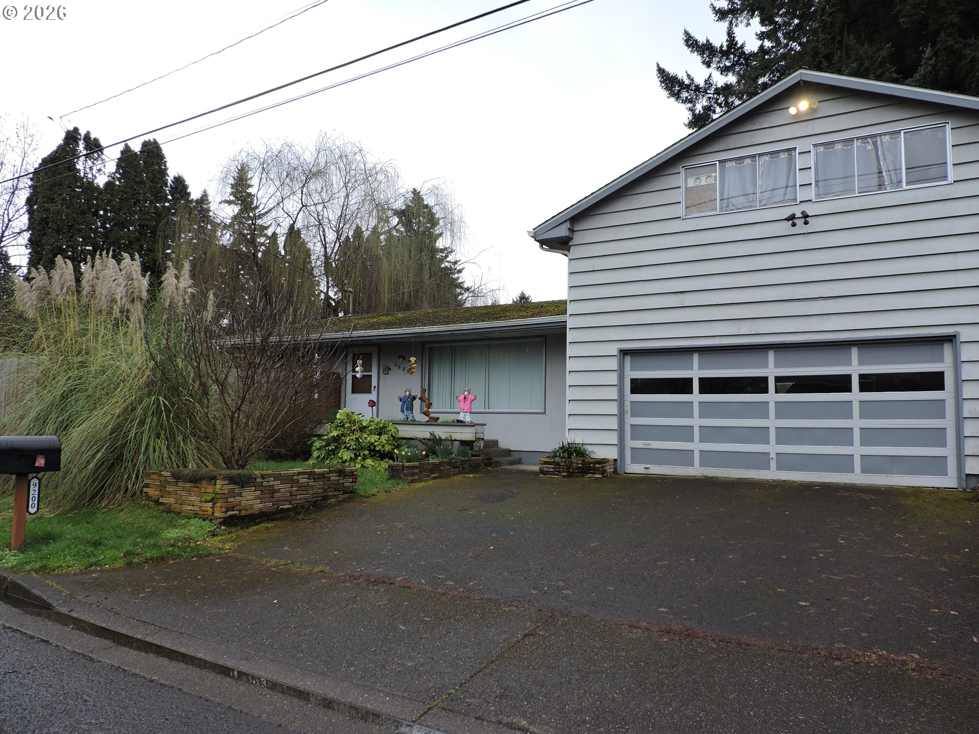 9200 Southwest Sagert Street Tualatin, OR 97062 - Photo 1 of 6 a view of a house with a yard and sitting area