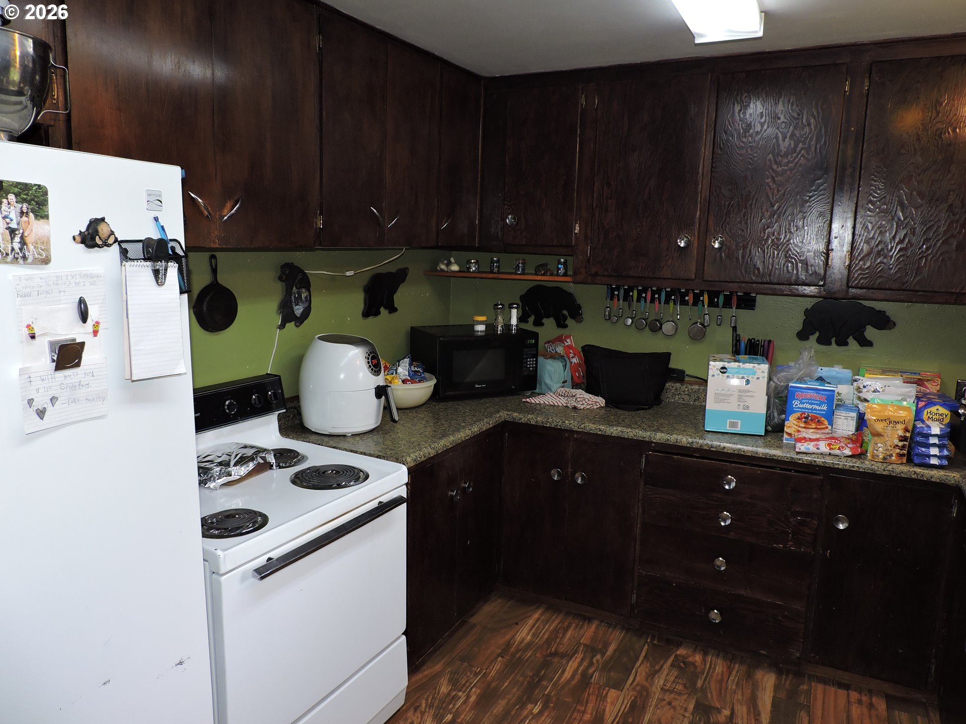 9200 Southwest Sagert Street Tualatin, OR 97062 - Photo 3 of 6 a kitchen with a cabinets and white appliances