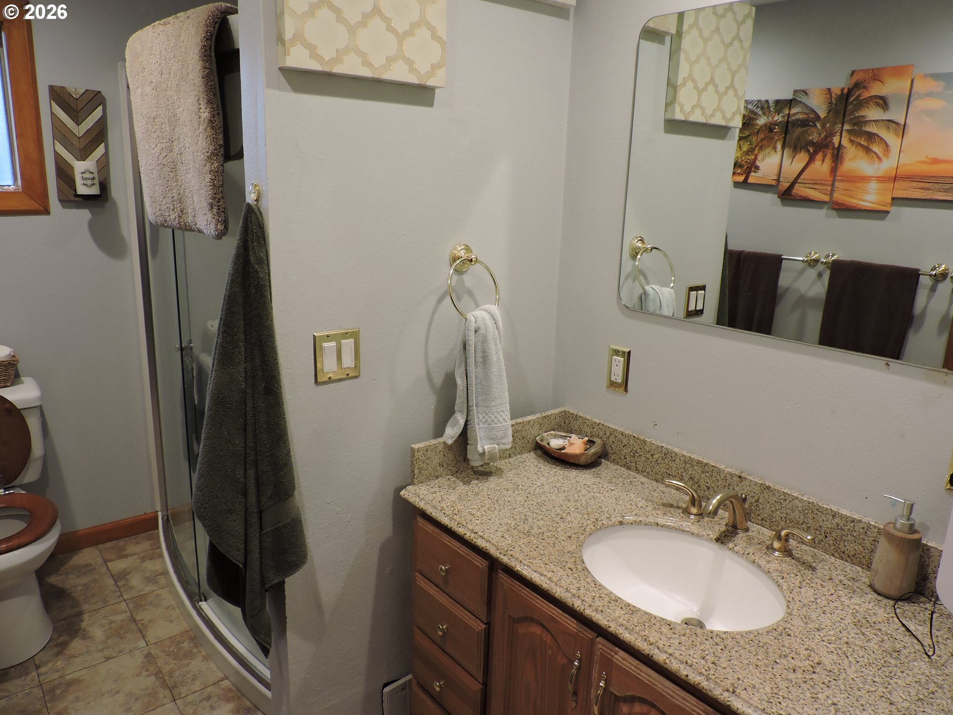 9200 Southwest Sagert Street Tualatin, OR 97062 - Photo 4 of 6 a bathroom with a granite countertop sink and a mirror