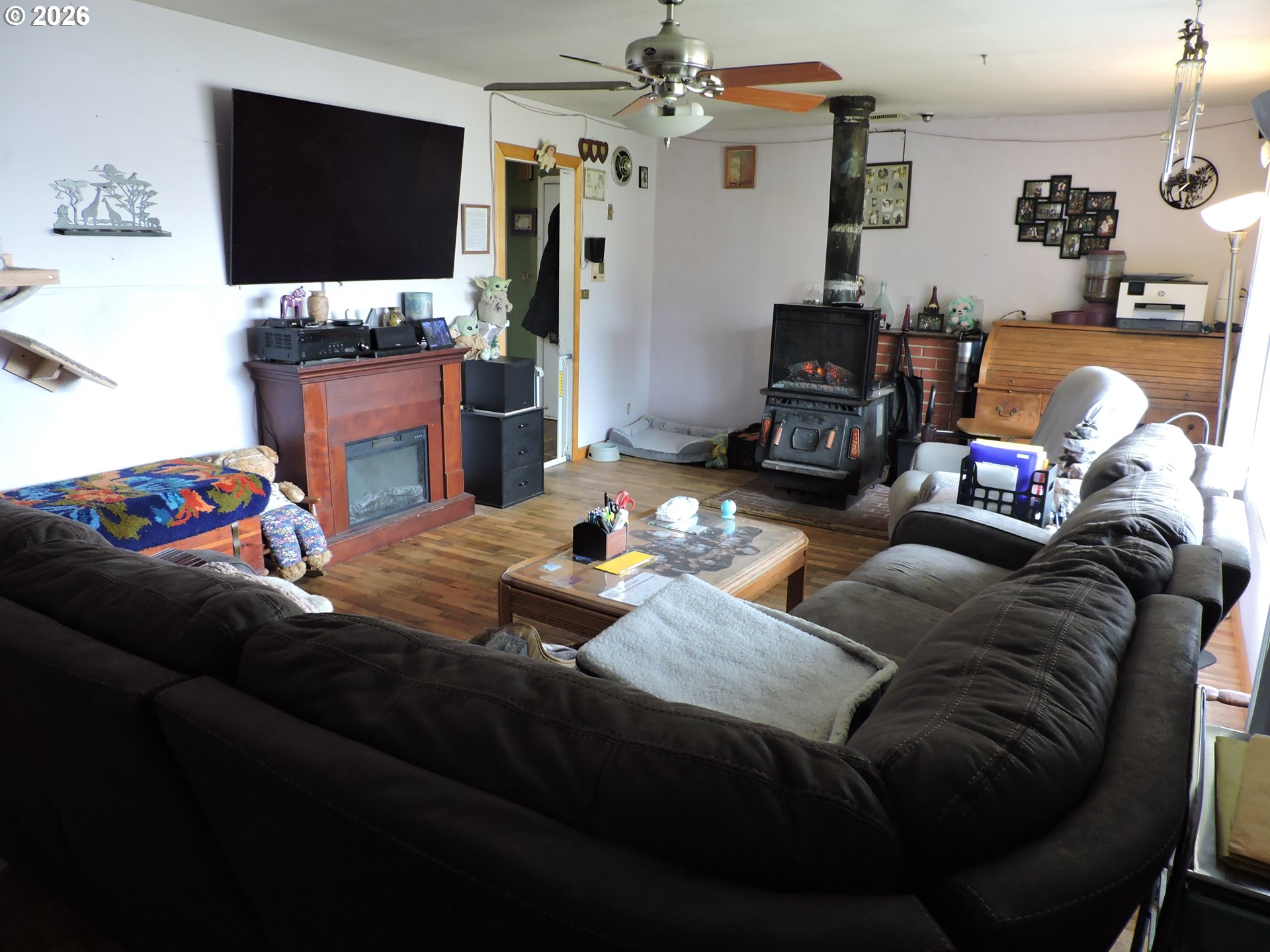 9200 Southwest Sagert Street Tualatin, OR 97062 - Photo 6 of 6 a living room with furniture a flat screen tv and a fireplace
