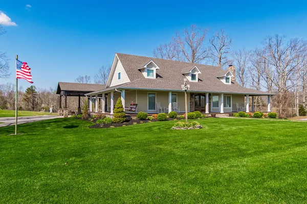 a front view of a house with a yard table and chairs