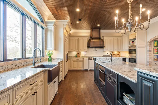 a kitchen with stainless steel appliances granite countertop a refrigerator and a stove