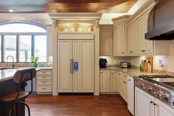 a kitchen with stainless steel appliances granite countertop a stove a sink and a microwave