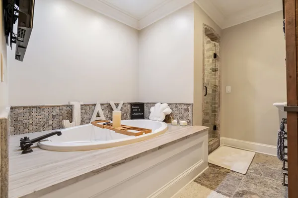 a view of a patio with table and chairs potted plants with wooden floor and seating space