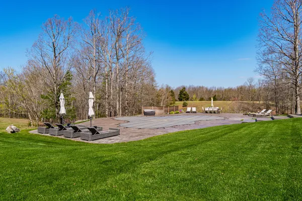 a view of a swimming pool and a yard