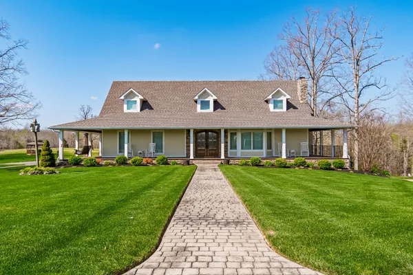 a view of a chair and tables in the patio next to a yard