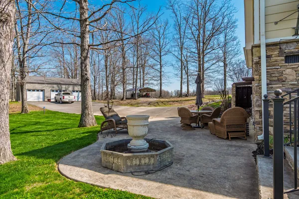 a view of a field with trees in the background