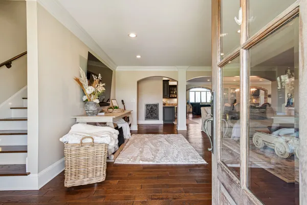 a living room with fireplace furniture and a wooden floor