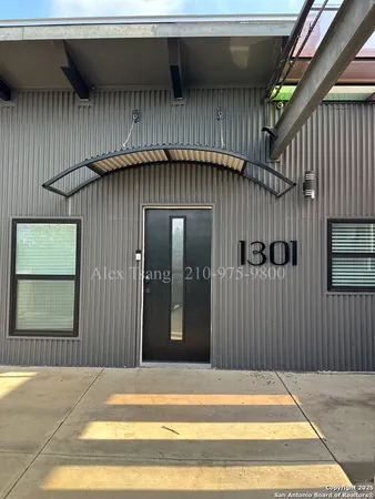 a view of a house with a door and wooden walls