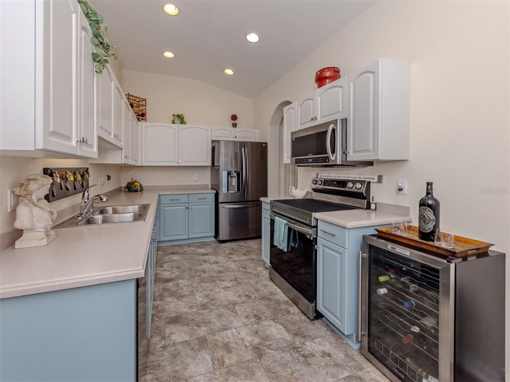 205 Reclinata Circle Venice, FL 34292 - Photo 20 of 62 a kitchen that has a sink cabinets stainless steel appliances and a counter top space