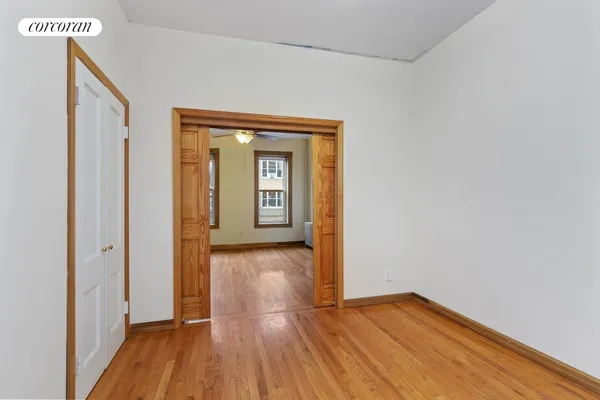 a view of a hallway with wooden floor