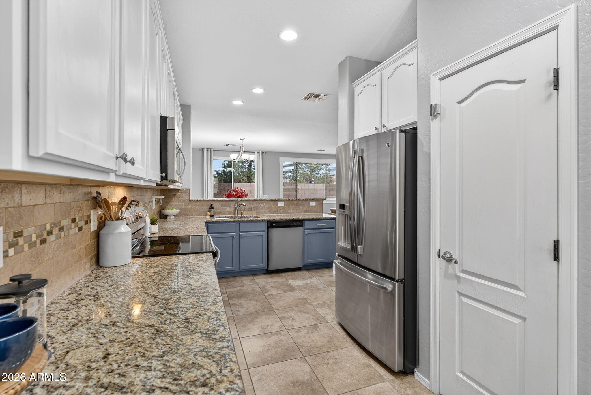 4052 East Milky Way Gilbert, AZ 85295 - Photo 12 of 73 a kitchen with a refrigerator sink and cabinets