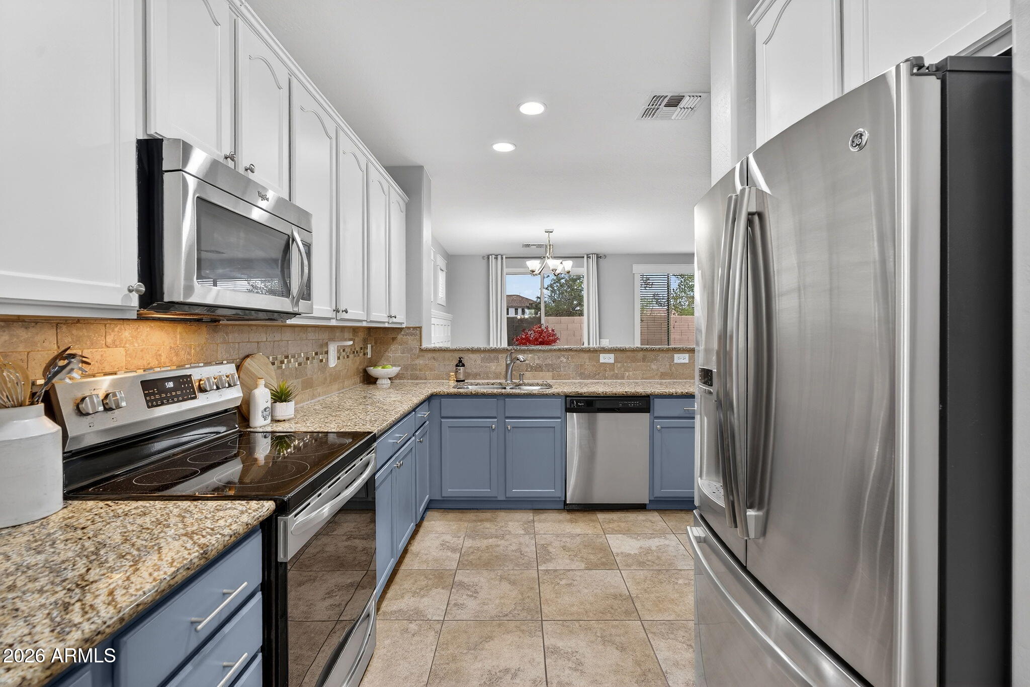 4052 East Milky Way Gilbert, AZ 85295 - Photo 13 of 73 a kitchen with granite countertop a sink stove and refrigerator