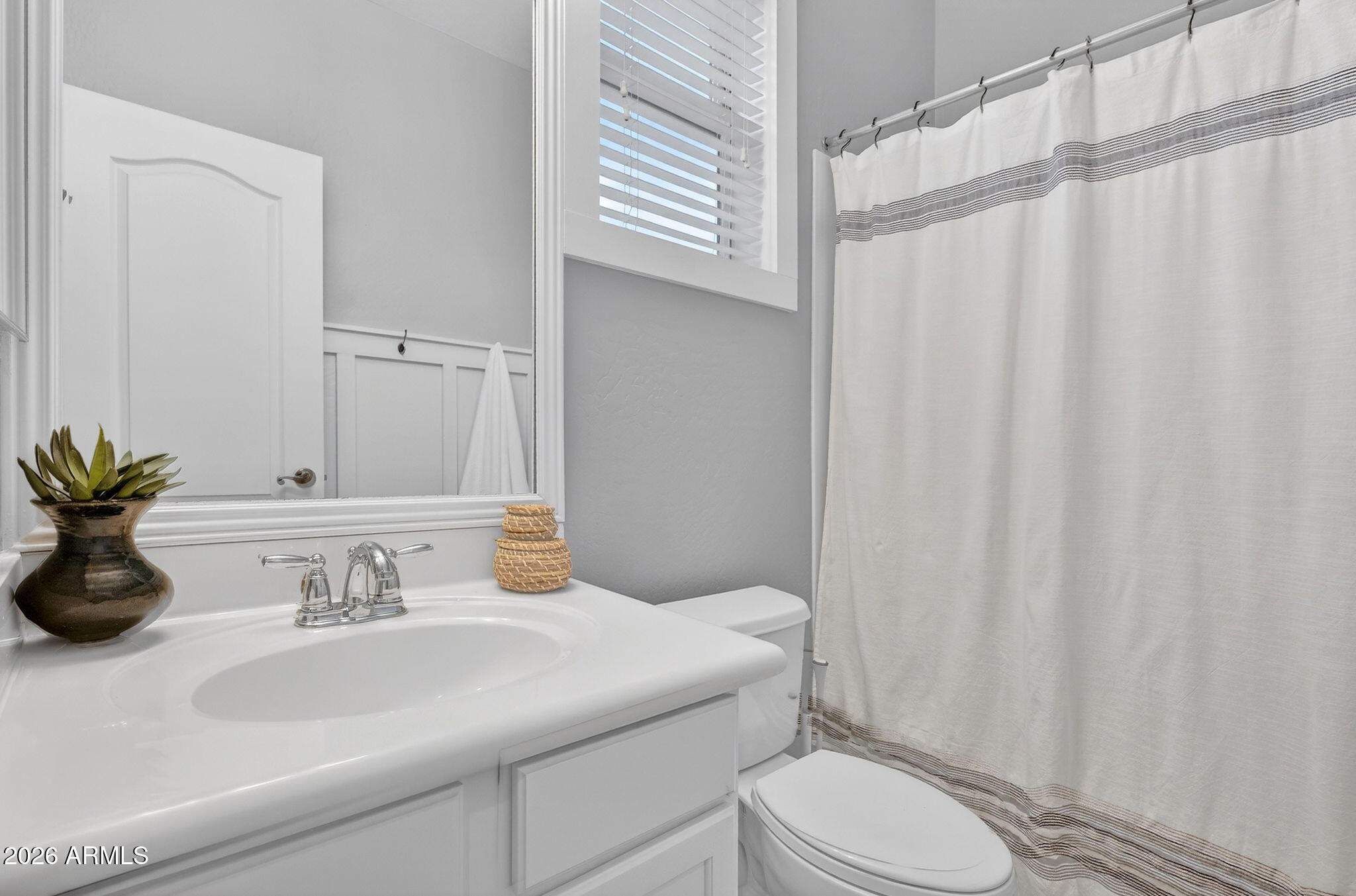 4052 East Milky Way Gilbert, AZ 85295 - Photo 36 of 73 a bathroom with a sink a toilet and shower curtain