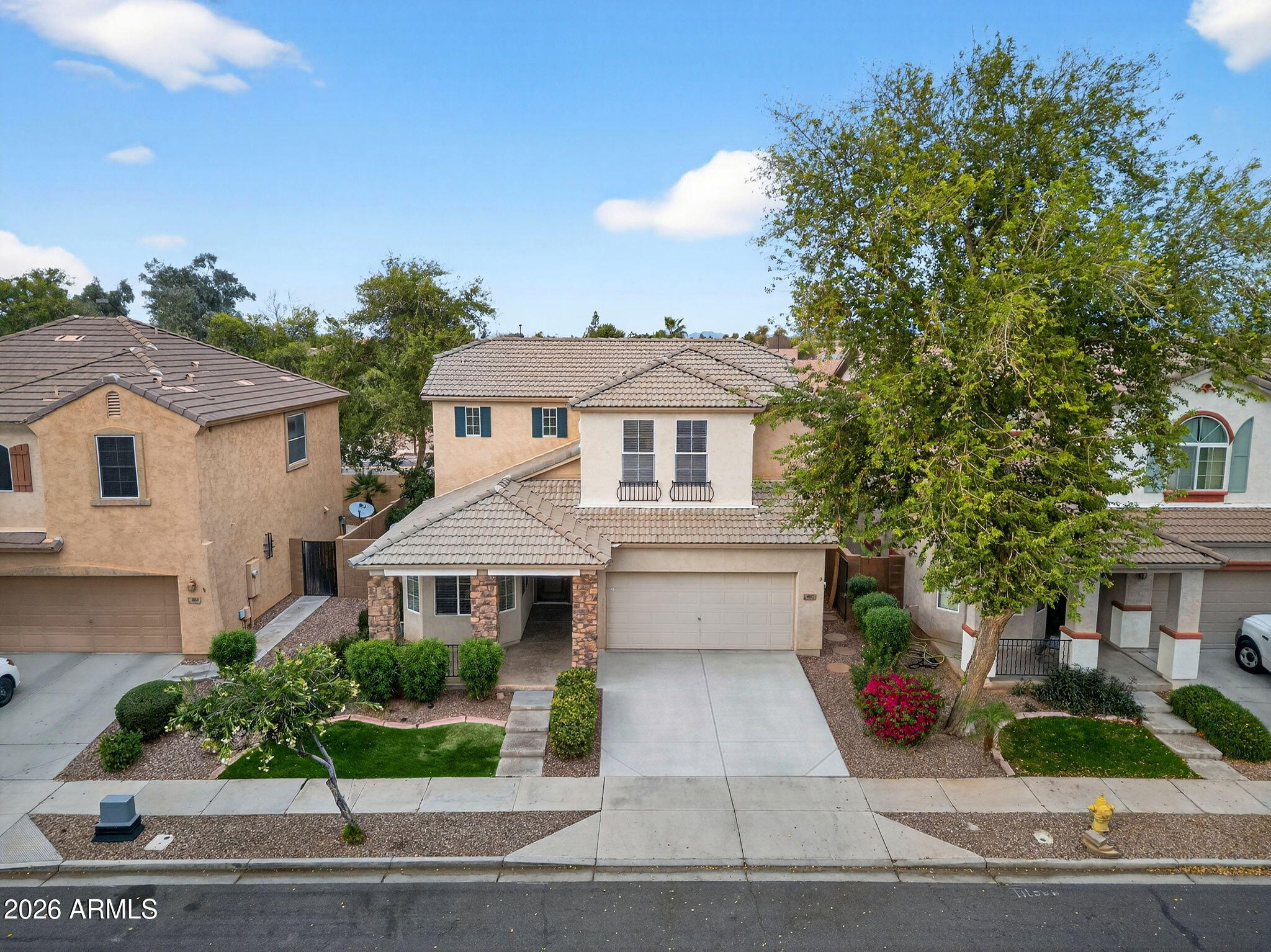 4052 East Milky Way Gilbert, AZ 85295 - Photo 59 of 73 a white house with a yard and table and chairs