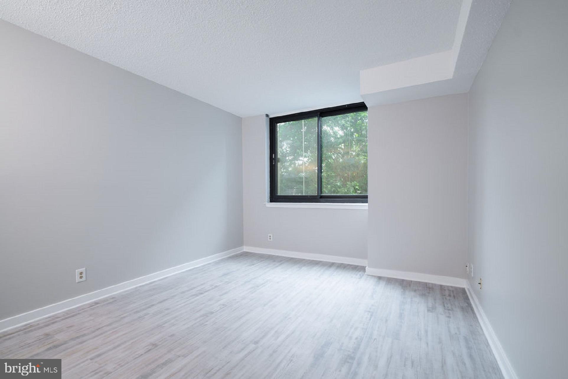 5505 Seminary Road, Unit 103N Falls Church, VA 22041 - Photo 20 of 59 an empty room with wooden floor and windows