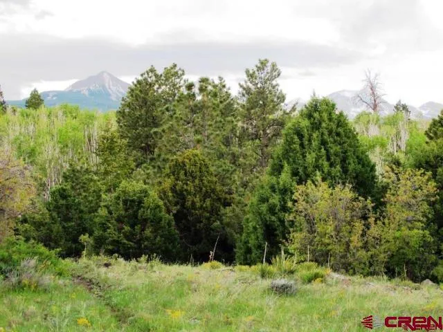 a view of mountain with sunset in background