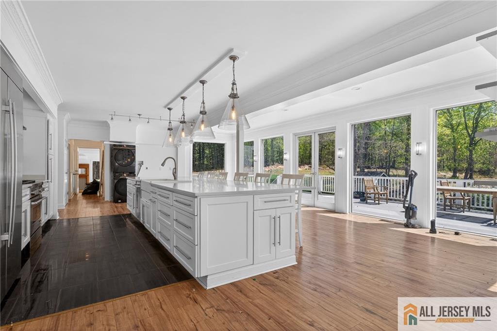 381 Monmouth Road Freehold, NJ 07728 - Photo 14 of 63 a large white kitchen with granite countertop a large counter top and stainless steel appliances