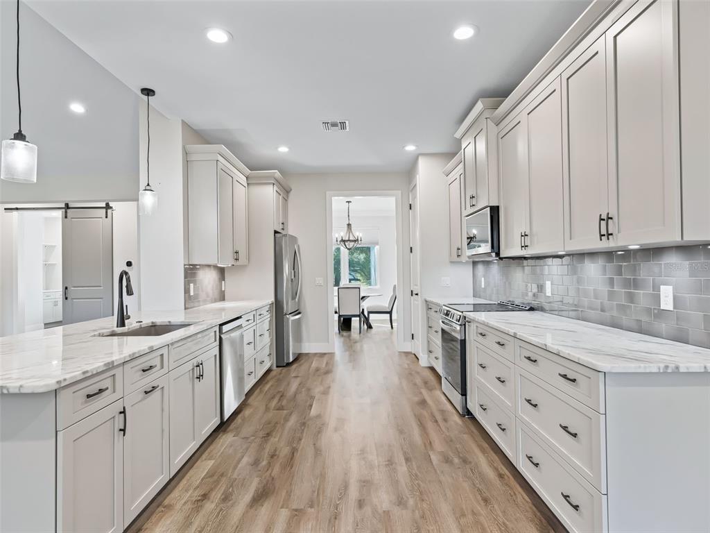 562 Dowling Circle Lady Lake, FL 32159 - Photo 15 of 62 a large kitchen with cabinets