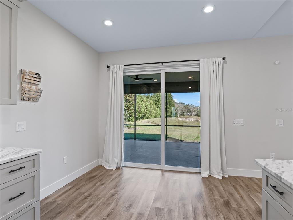 562 Dowling Circle Lady Lake, FL 32159 - Photo 20 of 62 an empty room with wooden floor and windows