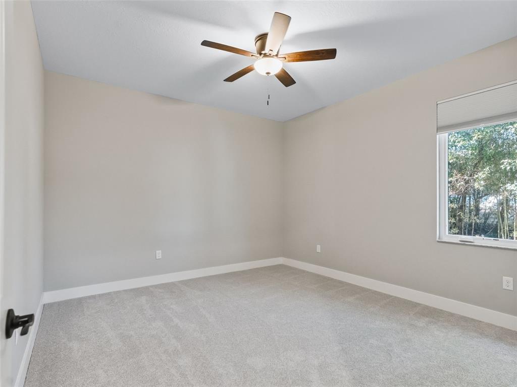562 Dowling Circle Lady Lake, FL 32159 - Photo 35 of 62 an empty room with a window and a ceiling fan
