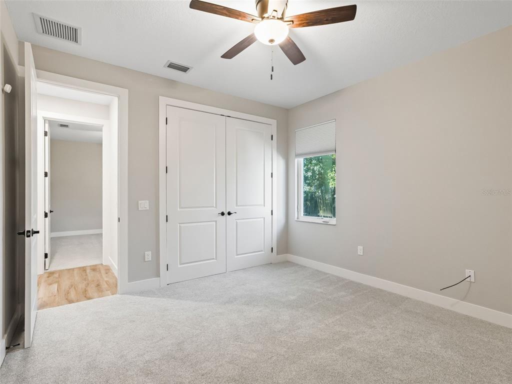 562 Dowling Circle Lady Lake, FL 32159 - Photo 40 of 62 a view of a room with a ceiling fan and a window