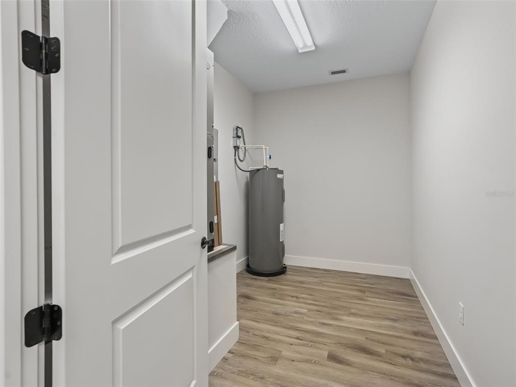 562 Dowling Circle Lady Lake, FL 32159 - Photo 41 of 62 a view of walk in closet with clothes and shoes