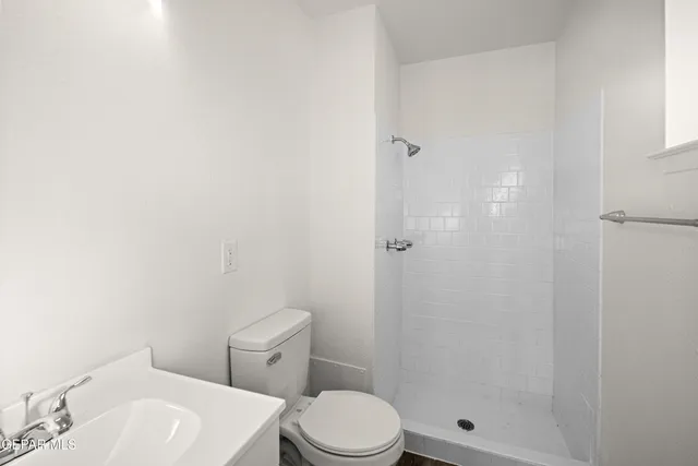 a white toilet sitting next to a bathroom sink