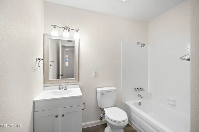 a bathroom with a toilet a sink and bathtub