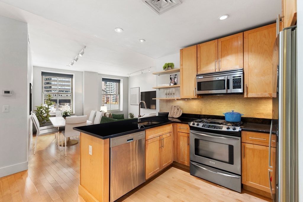 a kitchen with a sink stove and microwave