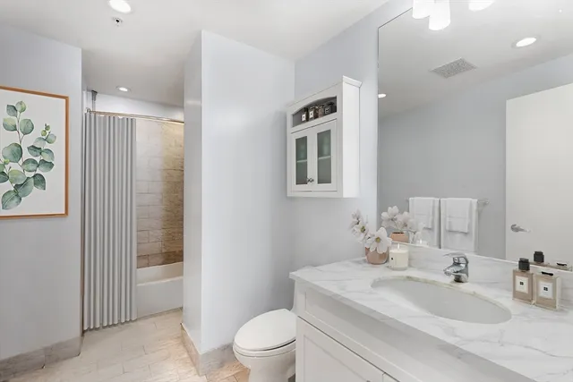a bathroom with a sink toilet and shower