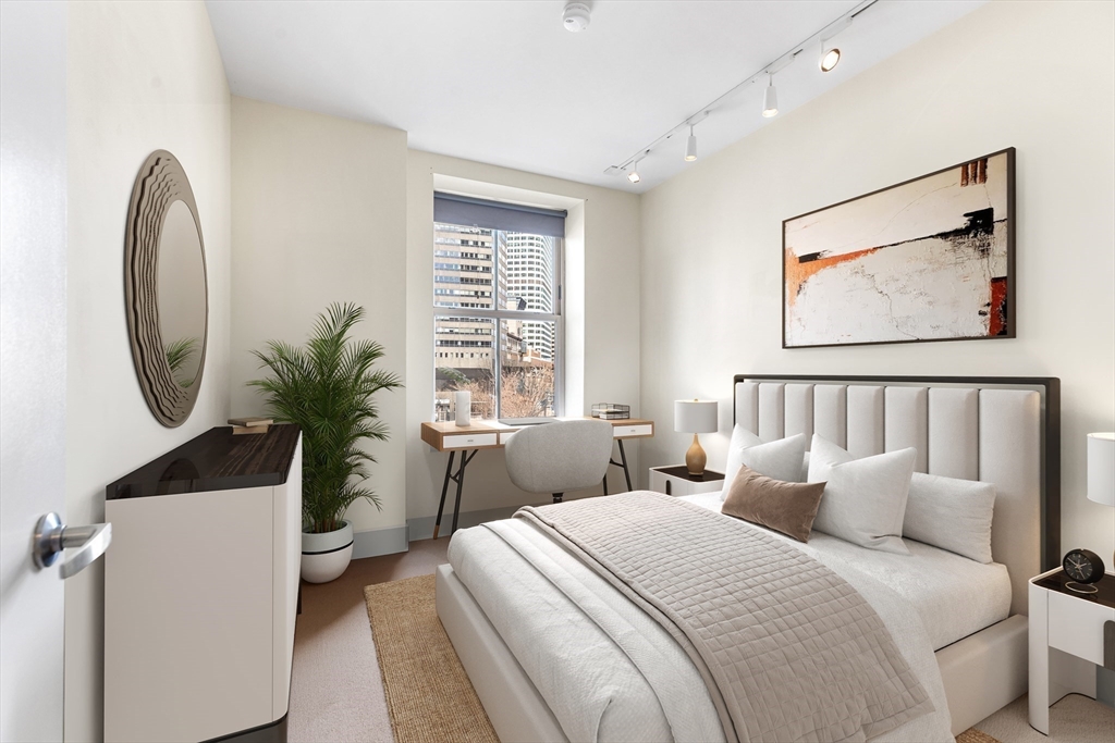 181 Essex Street, Unit E402 Boston, MA 02111 - Photo 6 of 10 a bedroom with bed and a potted plant next to a window