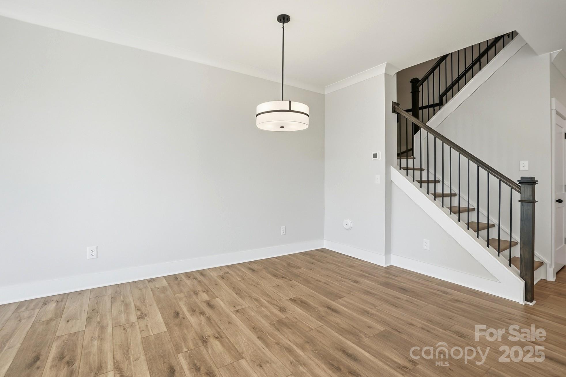 111 Viburnum Road Waxhaw, NC 28173 - Photo 14 of 39 a view of a room with wooden floor and white walls